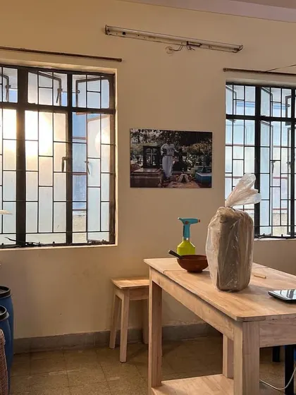 The pottery section of our studio, set up with wooden tables and shelves, ready for creative exploration. We are excited to offer classes in both hand-building and wheel-throwing techniques.