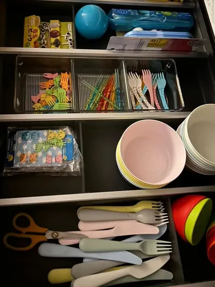 We created a dedicated kids' drawer in the kitchen. Having their own plates, bowls, and cutlery at their level encourages independence and helps them learn to put things away.