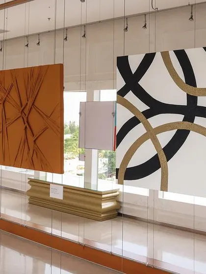 Abstract artworks with texture and bold lines from the 'Inner Tides' exhibition hanging in our UB City gallery.