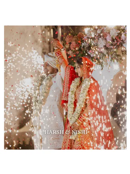 A celebratory shot of the couple surrounded by sparklers after their varmala. The warm glow and their joyful expressions make this a magical and memorable wedding photograph.