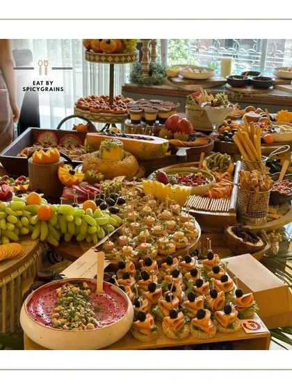A full view of one of our signature grazing tables. We believe in abundance and variety, ensuring there's a delicious discovery for every guest, from savory cheese and crackers to sweet fruits and desserts.