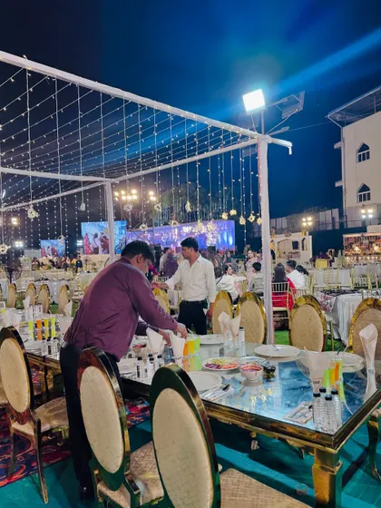 Staff making final preparations at the long dining tables.