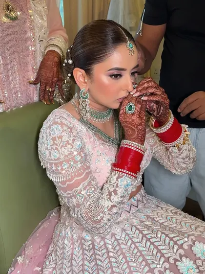A quiet, prayer-like moment. The makeup is subtle yet polished, giving the bride a serene and angelic glow for her special day.