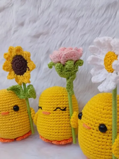 A closer look at the three ducks with their flowers. The detailed stitching on their faces and the flowers showcases the quality of my work.