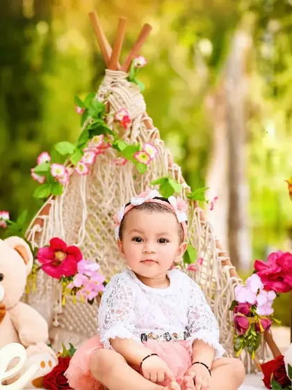 Evika's pre-birthday session featured this lovely boho-chic teepee setup with flowers and teddy bears, perfect for an outdoor shoot.