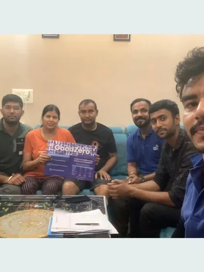 Our team takes a selfie with a family holding our "GoodZero" brochure.