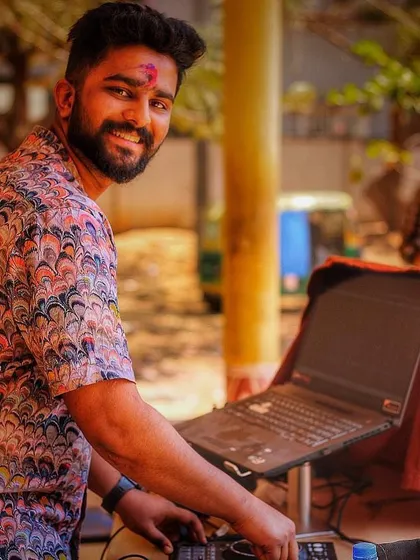 A smile during a Holi celebration. Even when covered in color, the focus is on the music.