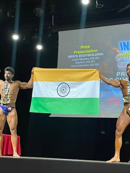 Sharing the stage and the Indian flag with a fellow competitor.