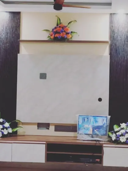 Simple touches can make a big difference. For this housewarming, we placed elegant floral arrangements on the TV unit to bring a touch of nature and festivity into the living space.