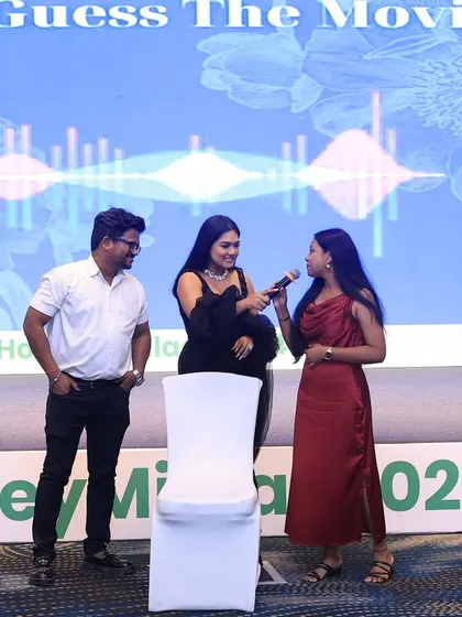 Leading a fun "Guess The Movie" game during the Housiey awards night. Interactive games are a great way to keep the energy high between formal presentations.