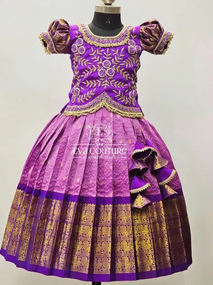A Kanchipattu lehenga with a heavily embroidered purple blouse. The intricate gold threadwork creates a beautiful pattern across the entire blouse.