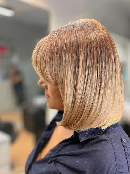 To maintain a cool-toned blonde, a color refresh is essential. We neutralized any warmth to preserve this stunning, clean blonde on her chic bob.