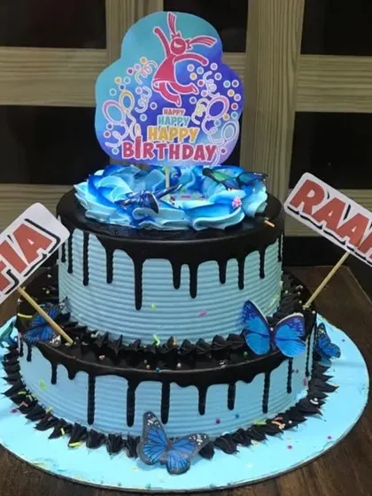 A two-tier Choco-Blueberry cake with a striking blue color and rich chocolate drip. This is a great choice for a shared birthday celebration.