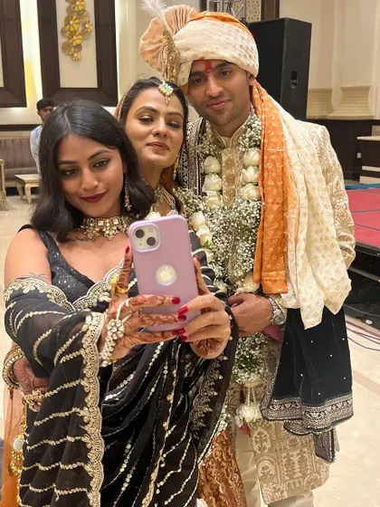 Capturing memories with the happy couple. A group selfie is a must at any Indian wedding.