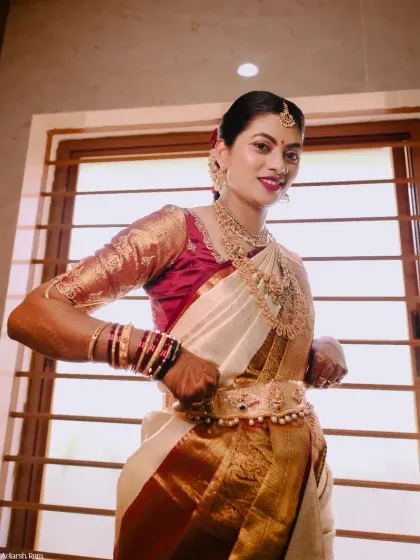 A confident and stylish pose by the bride. Her makeup and hair are perfect, and she is ready to celebrate her big day.