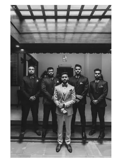 The groom and his groomsmen, looking sharp and ready for the big moment. A classic black and white portrait of camaraderie.