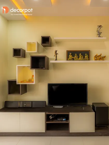 A playful and modern TV unit design featuring a mix of open and closed floating shelves in various sizes. This asymmetrical layout is perfect for displaying books, decor, and personal items.