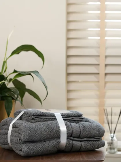 A set of grey towels, part of the same product line. Our systematic approach ensures all color options are represented beautifully.
