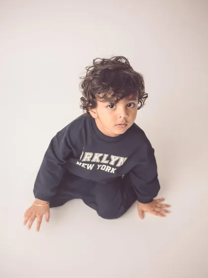This little guy looks like he's straight out of a magazine. A simple, clean background is perfect for creating modern, ad-style portraits.