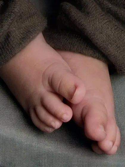 A macro detail shot focusing on the tiny, perfect toes of a newborn. We believe in capturing every little detail, as these are the features that change so quickly.