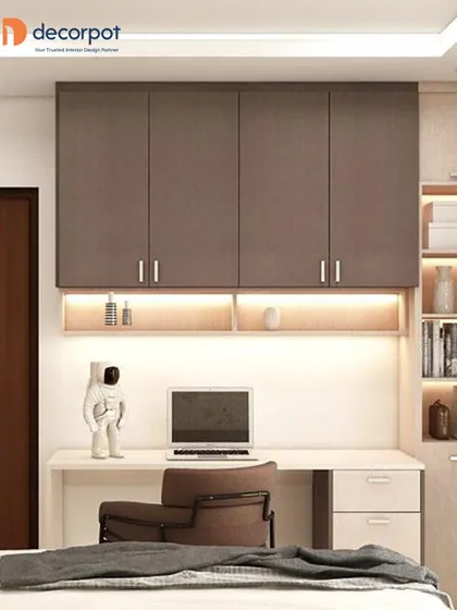 This bedroom study unit features brown overhead cabinets and a light-colored desk. The design is clean and functional, with an astronaut figurine adding a touch of personality.
