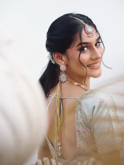 A stunning engagement bridal inspiration shot, with a focus on the beautiful smile and pastel lehenga.