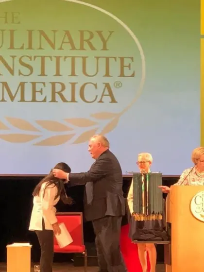 A photo of me receiving my diploma at the Culinary Institute of America. A proud moment that marked the start of my culinary career.