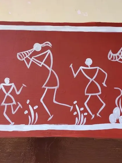 A detailed section of the school mural border. This panel shows a festive procession with figures playing traditional instruments like the tarpa, capturing the spirit of celebration in simple geometric shapes.