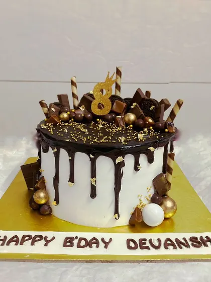 A delicious vanilla cake loaded with chocolate bars, wafers, and Ferrero Rocher.