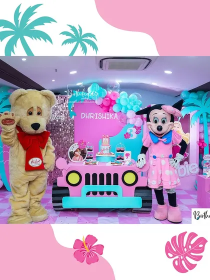 Character mascots bring the theme to life! Here, Minnie Mouse and a friendly teddy bear pose with guests at a Barbie-themed celebration.