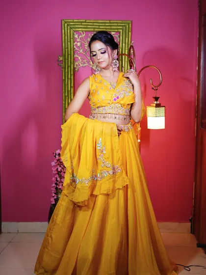 A full-length view of the yellow Haldi lehenga with a stylish belted dupatta, perfect for a fun and festive look.