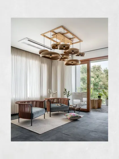 The private lounge in the Kamala Residence features locally sourced black Kadappa stone flooring. The space is made cozy with comfortable Alton chairs and warm, hand-crafted bamboo lights.