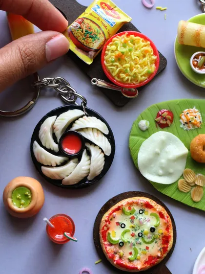 A beautiful collection of miniatures including pizza, momos, Maggi, and a South Indian meal.