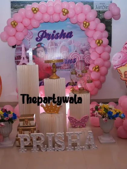 A sweet Candyland theme with donut and ice cream props and a pink balloon arch.