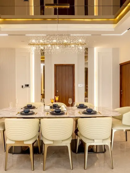 Luxury dining defined by a marble-top table, elegant leather-upholstered chairs, and a magnificent crystal chandelier. The mirrored ceiling inlay and wall panels amplify light and add a sense of grandeur to every meal.