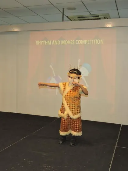 This student, in a unique costume, showcases her budding dance skills and confidence at the 'Rhythm and Moves' competition.