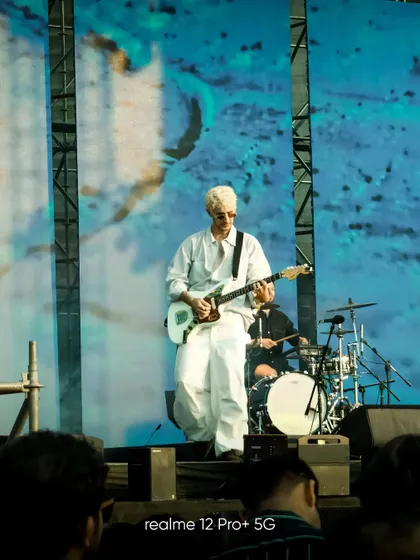 A guitarist on stage at Lollapalooza, captured in a clean, well composed shot from the audience. It demonstrates the ability to get quality photos even in challenging concert lighting.