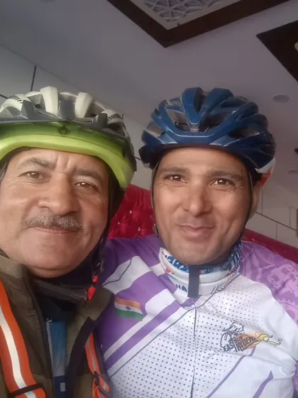 A selfie capturing a moment of friendship and support between two senior riders during a long-distance event.