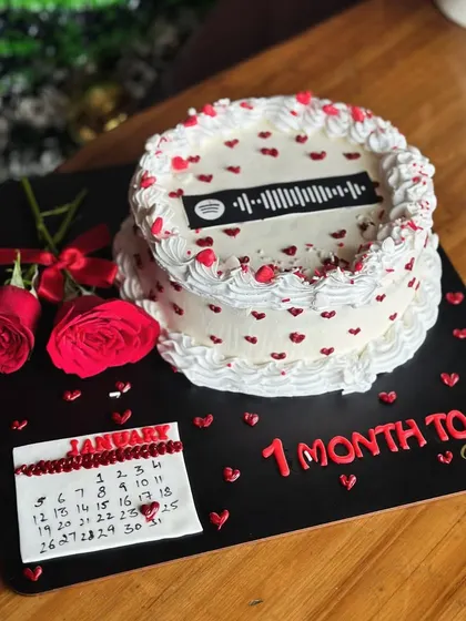 Counting down the days to a love-filled celebration. This unique cake features a calendar marking a special date and a scannable Spotify code for your favorite song.