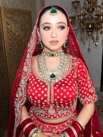 A classic bridal portrait. This look features a clean, matte base with soft brown smokey eyes and a nude lip, letting the magnificent emerald jewelry stand out.