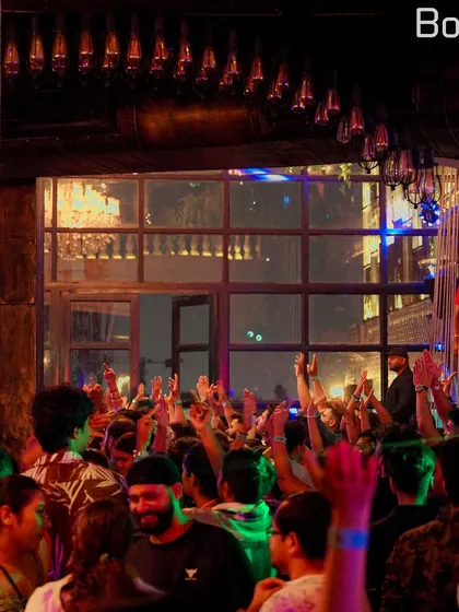 The elegant interior of Bombay Adda, packed with people ready to party. I can adapt my style to fit the vibe of any venue, from gritty clubs to upscale lounges.