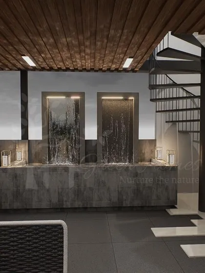 A key feature of our Ashok Vihar terrace project is this dual waterfall feature and a spiral staircase. This demonstrates our ability to incorporate custom hardscaping and multi-level access into our designs.