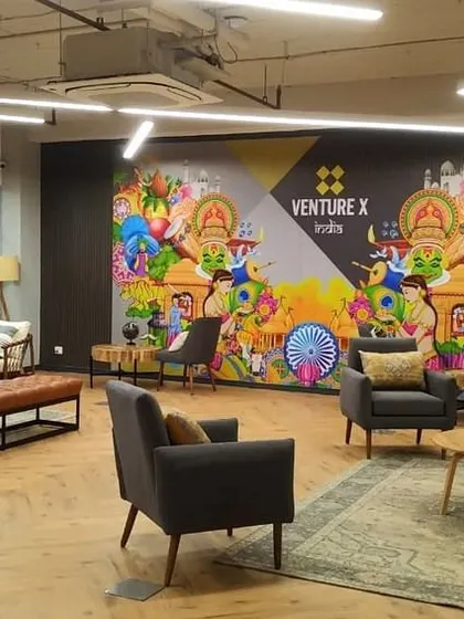 The main lounge at VentureX, featuring a large, colorful mural that adds a local, artistic touch. The comfortable and eclectic mix of seating makes it an ideal spot for informal meetings or relaxation.