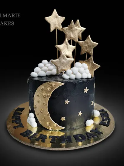 An eggless chocolate truffle cake with a celestial theme. The black fondant is decorated with a golden moon and stars, creating a dreamy night sky effect.