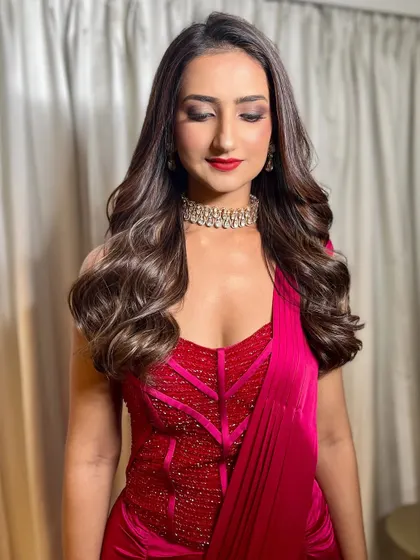 Step right up to a spectacle of sparkle and style. This look features a bold red lip, smokey eyes, and voluminous waves, perfect for a glamorous evening event.