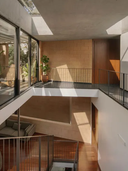 A subtle shift in the multi-level open staircase of the Debris Block House brings a dance of light from strategic skylights down to the ground floor. The interplay of light, shadow, and material is a key element of the design.