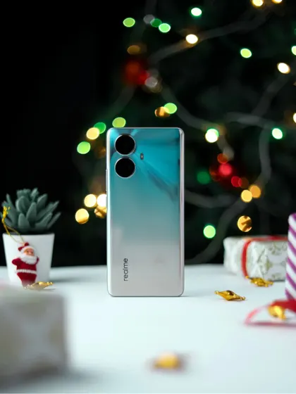 The realme 10 Pro+ 5G phone itself in a Christmas setting, with bokeh lights creating a magical atmosphere.