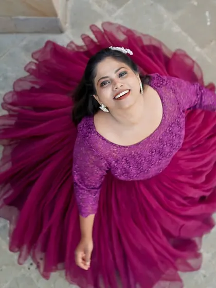 A creative top-down shot of a bride in a flowing purple gown, creating a beautiful circular pattern with her dress.