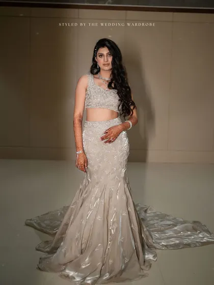 The bride's stunning mermaid-style gown with its long train, a perfect statement for a glamorous reception.