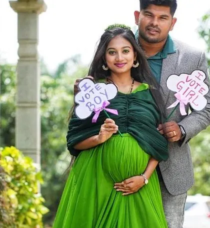 A happy couple during their maternity shoot. The "I vote boy/girl" signs add a fun touch to the pictures.